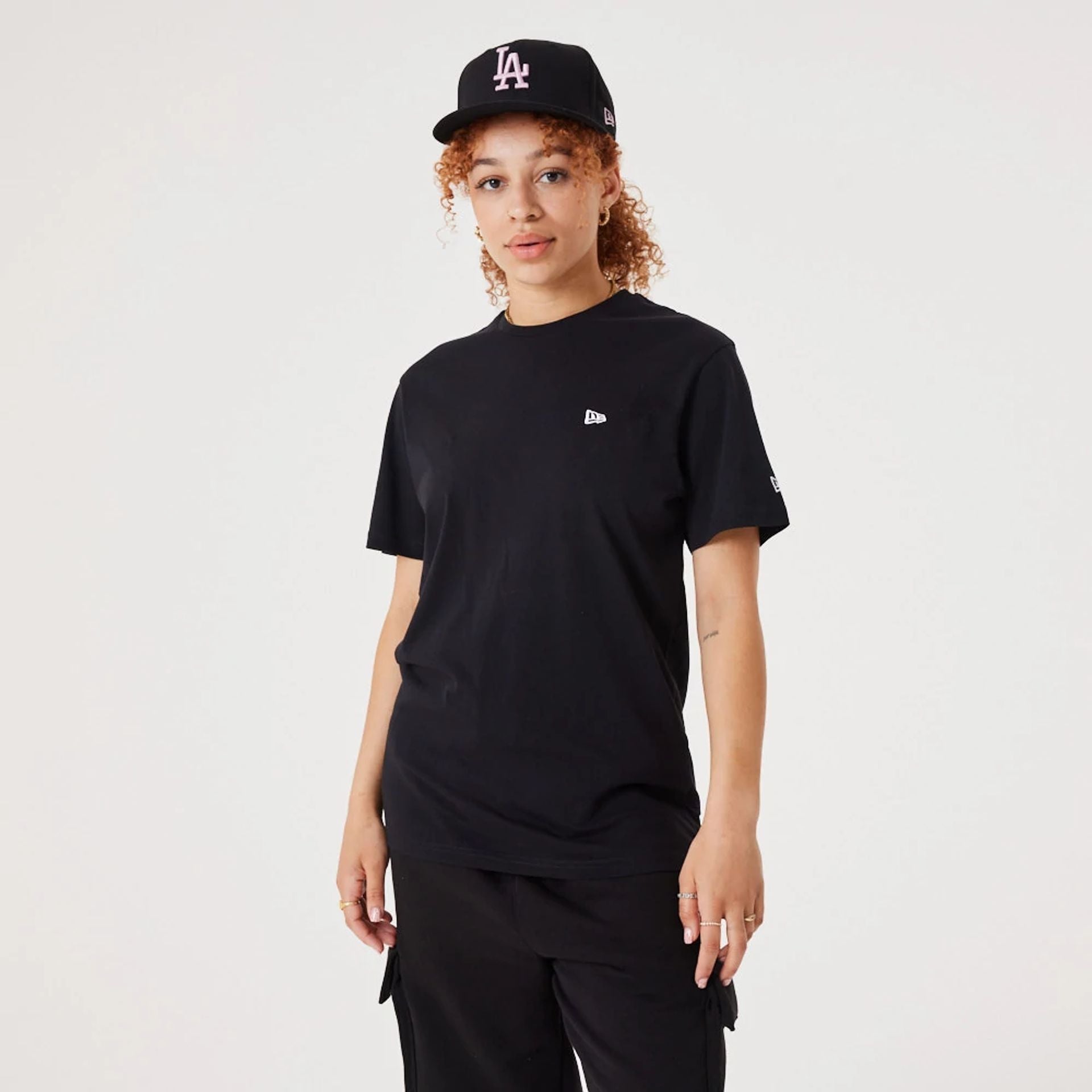 The Male model is wearing New Era Essential Black T-Shirt 3