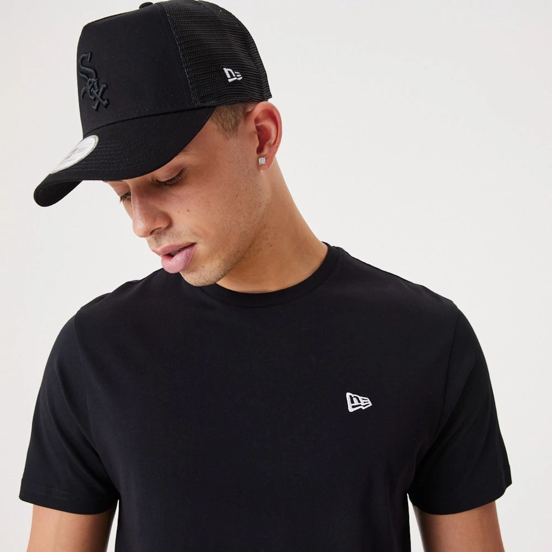 The Male model is wearing New Era Essential Black T-Shirt 5