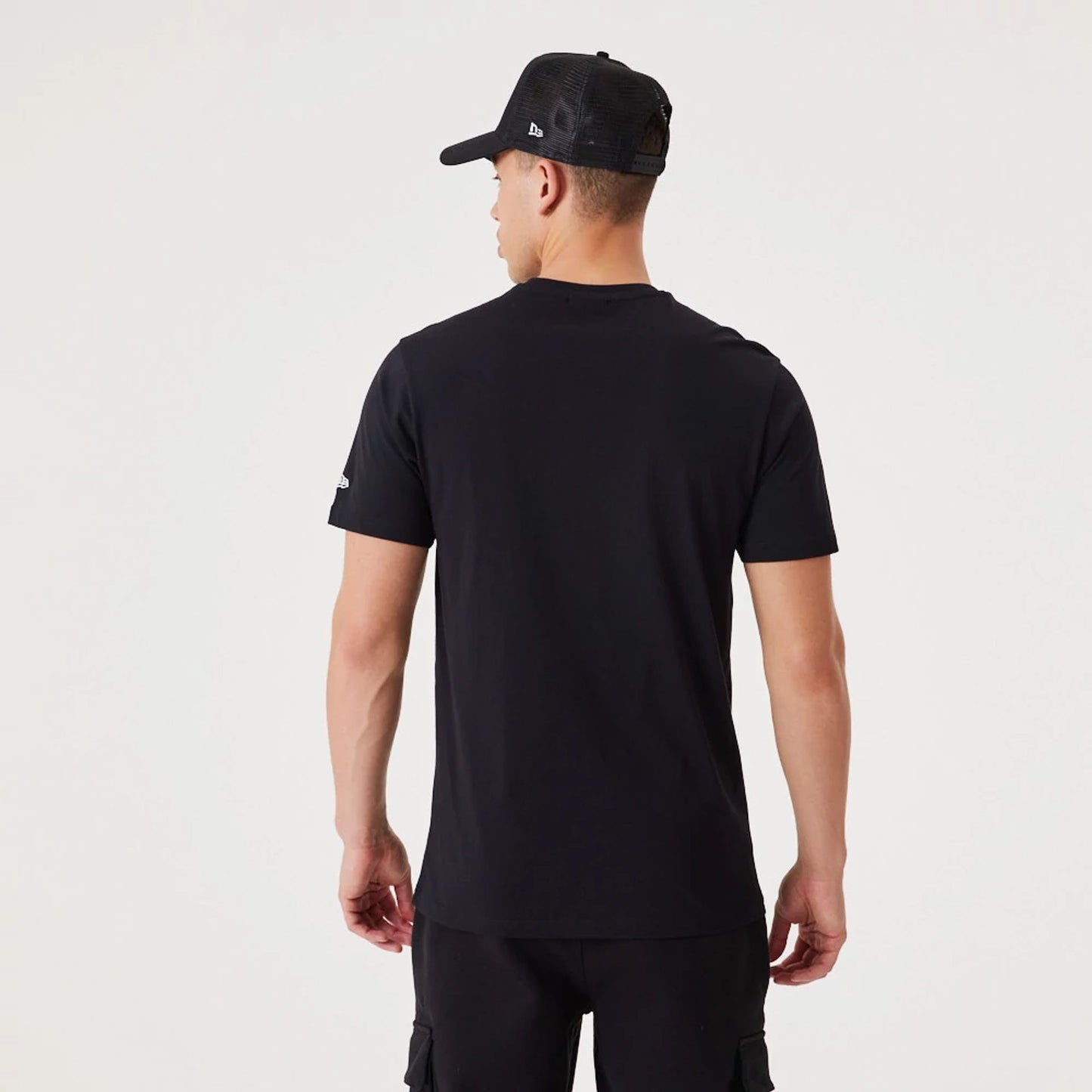 The Male model is wearing New Era Essential Black T-Shirt 6