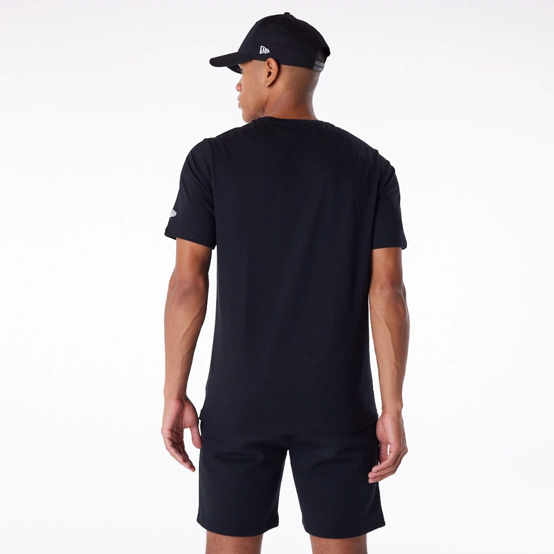 The Male model is wearing New Era Essential Black T-Shirt 7