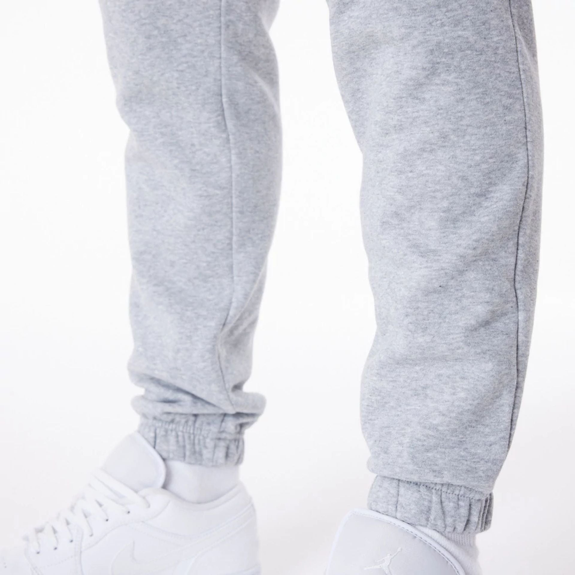 The Male model is wearing New Era Essential Grey Joggers 4