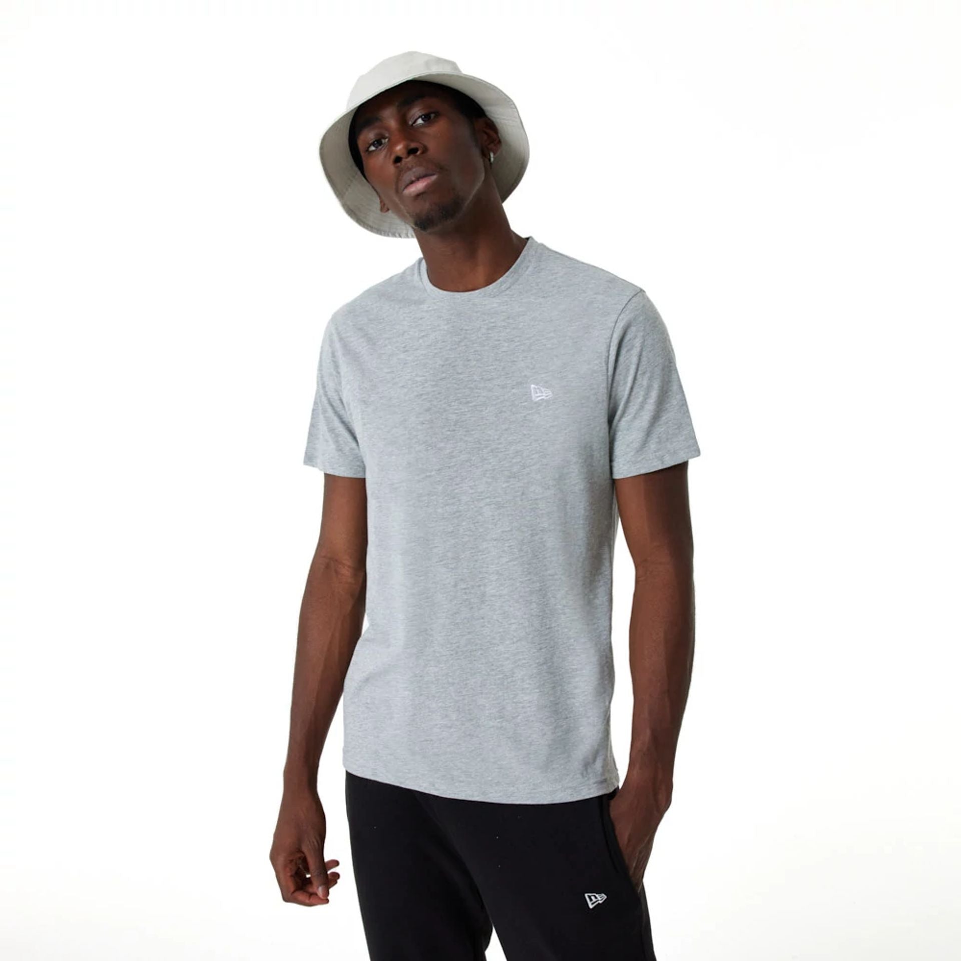 The Male model is wearing New Era Essential Grey T-Shirt 1