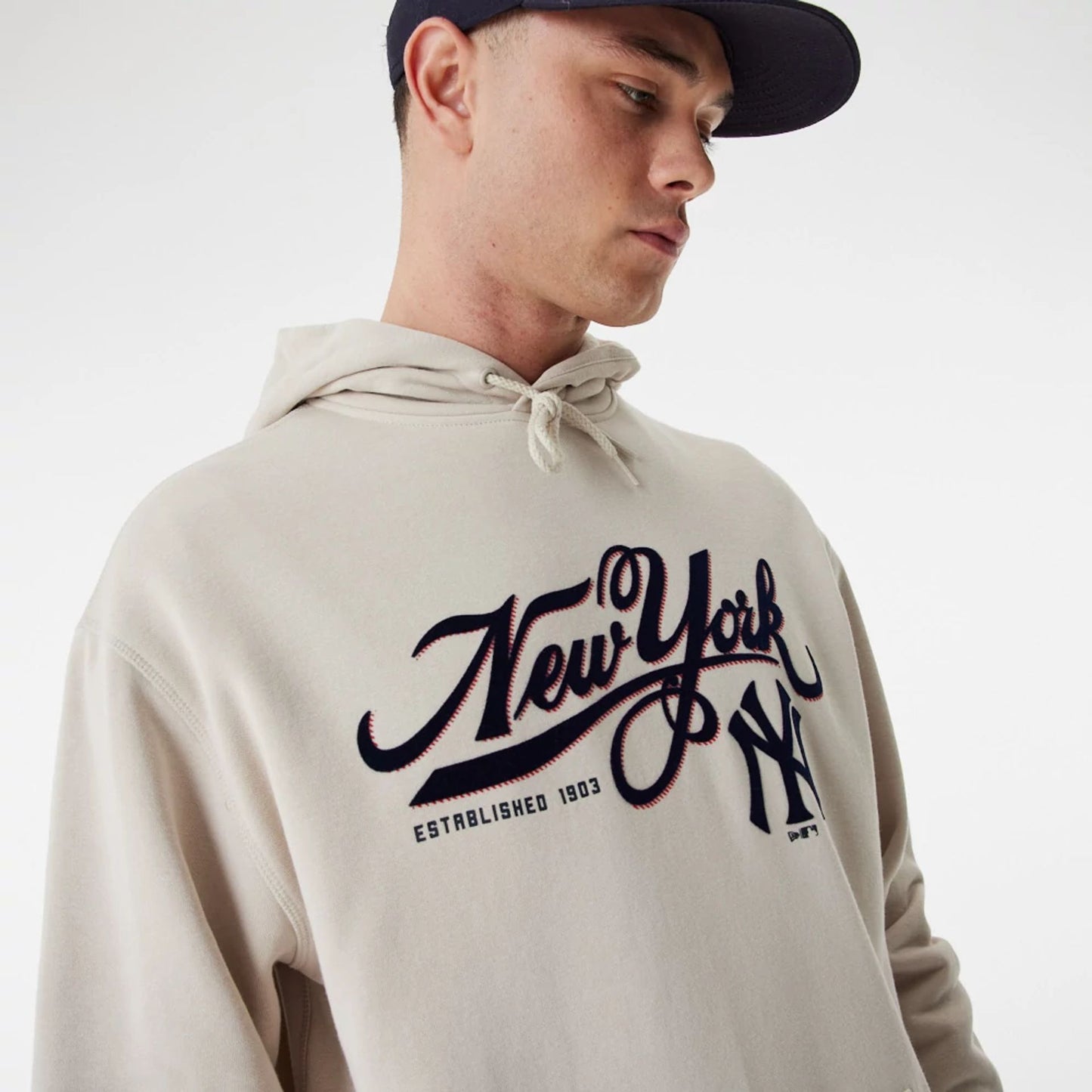 The Male model is wearing New York Yankees MLB Team Retro Graphic Light Beige Oversized Hoodie 4