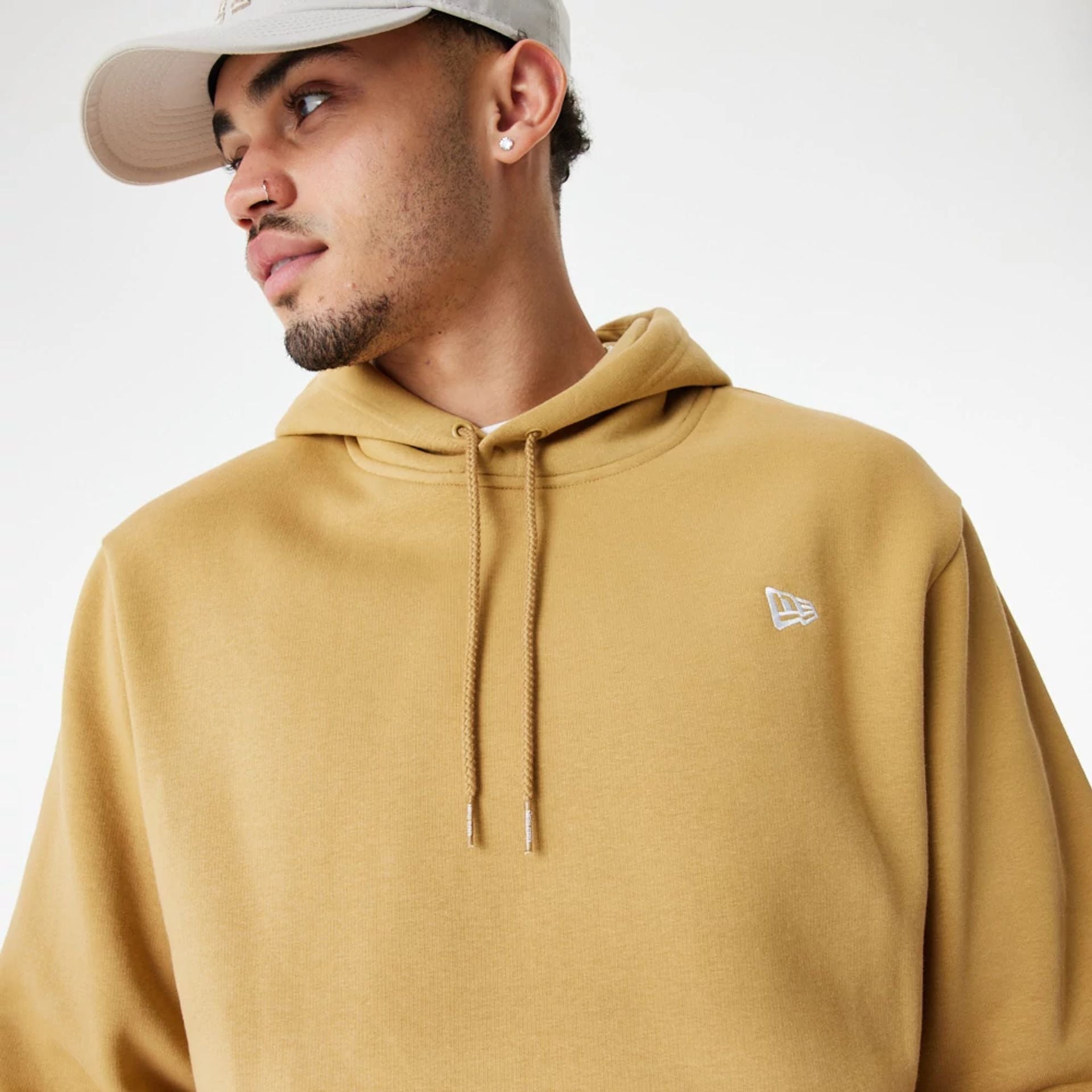 The Male model is wearing New Era Essentials Flag Brown Hoodie 4