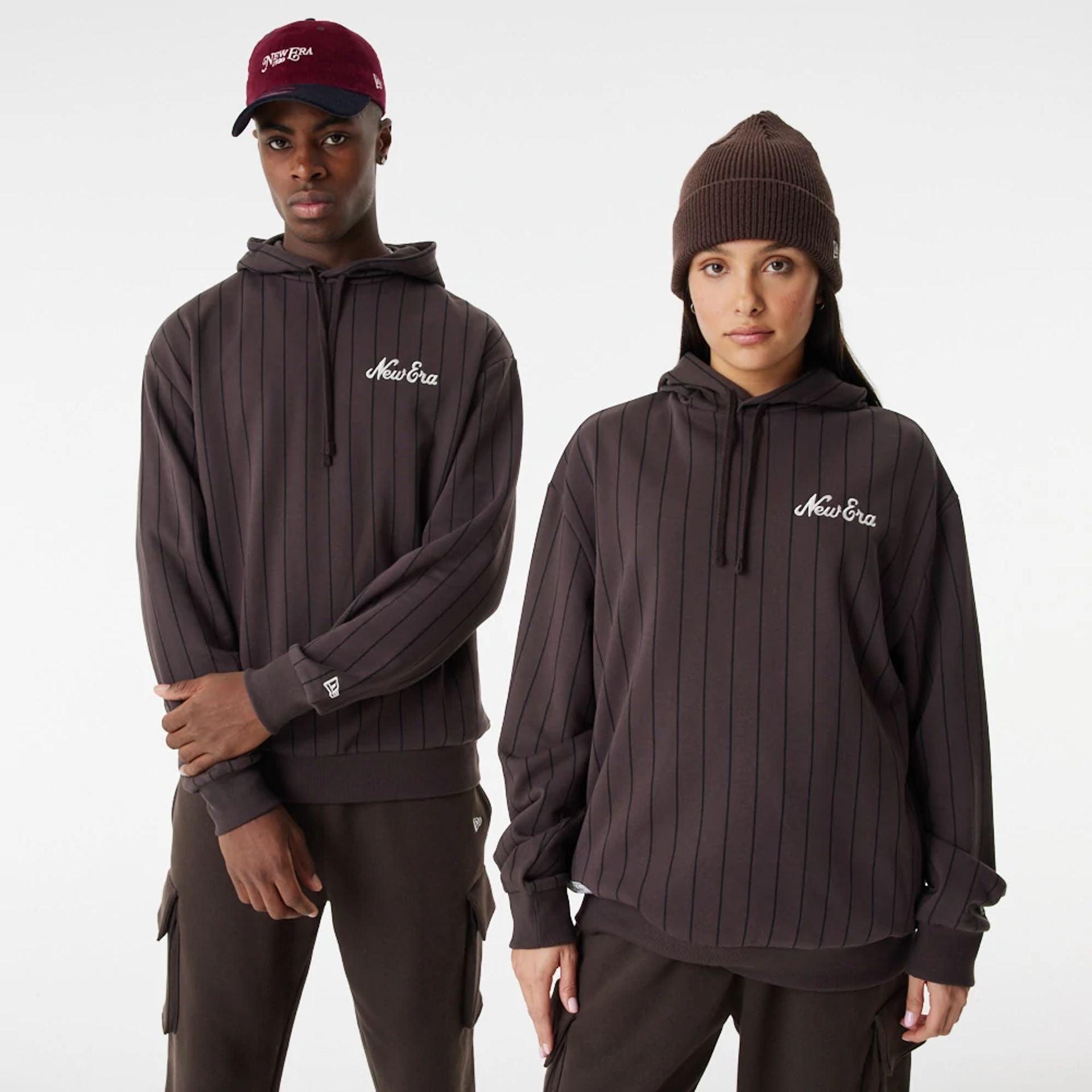 The Male model is wearing New Era Heritage Pinstripe Brown Oversized Hoodie 1