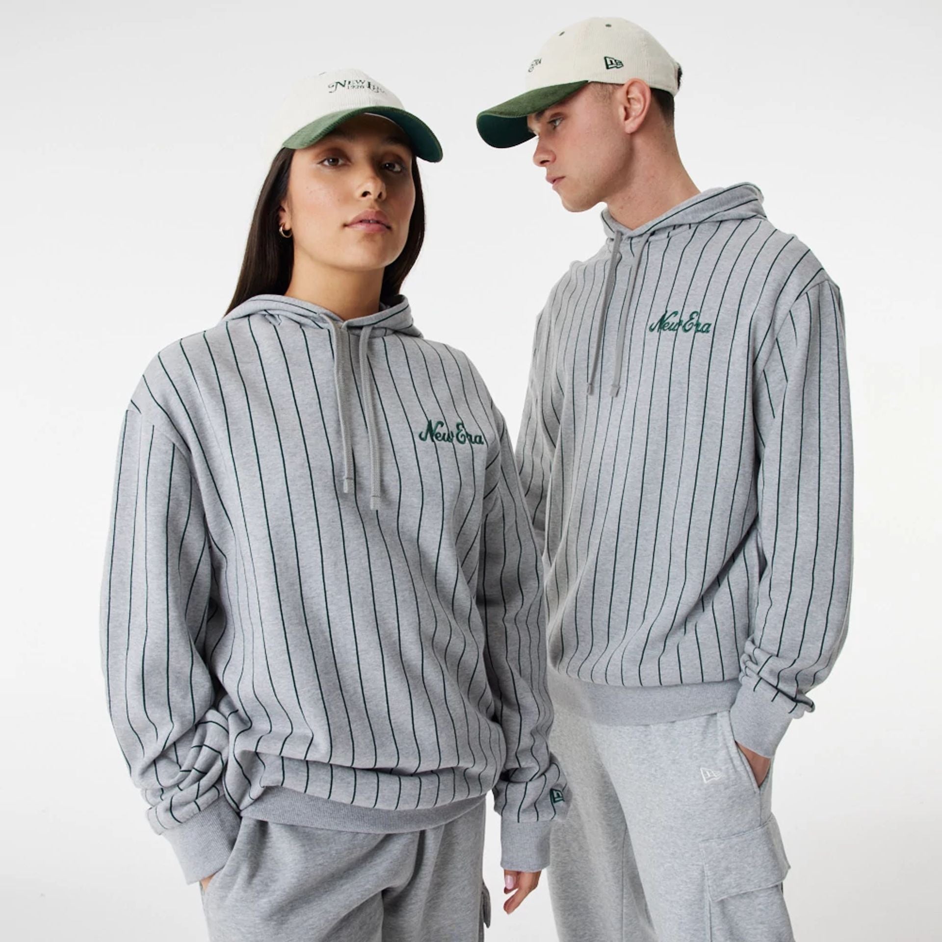 The Male model is wearing New Era Heritage Pinstripe Grey Oversized Hoodie 1