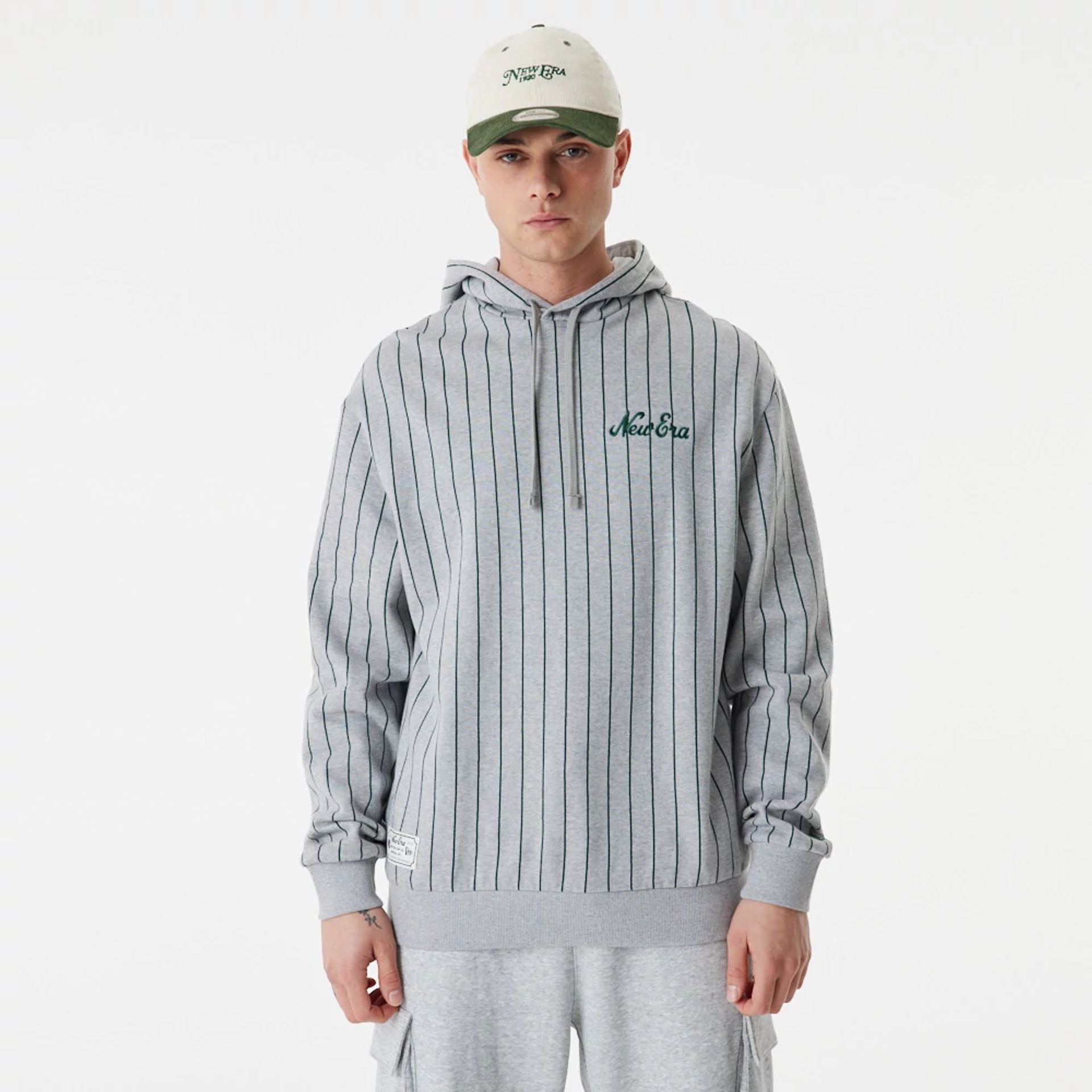 The Male model is wearing New Era Heritage Pinstripe Grey Oversized Hoodie 2