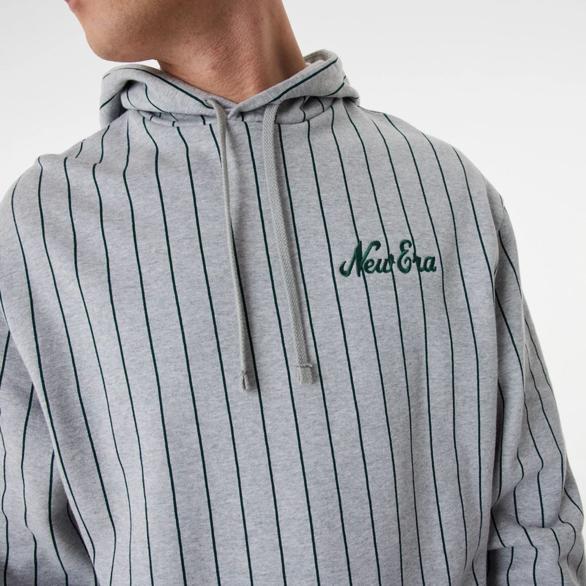 The Male model is wearing New Era Heritage Pinstripe Grey Oversized Hoodie 4