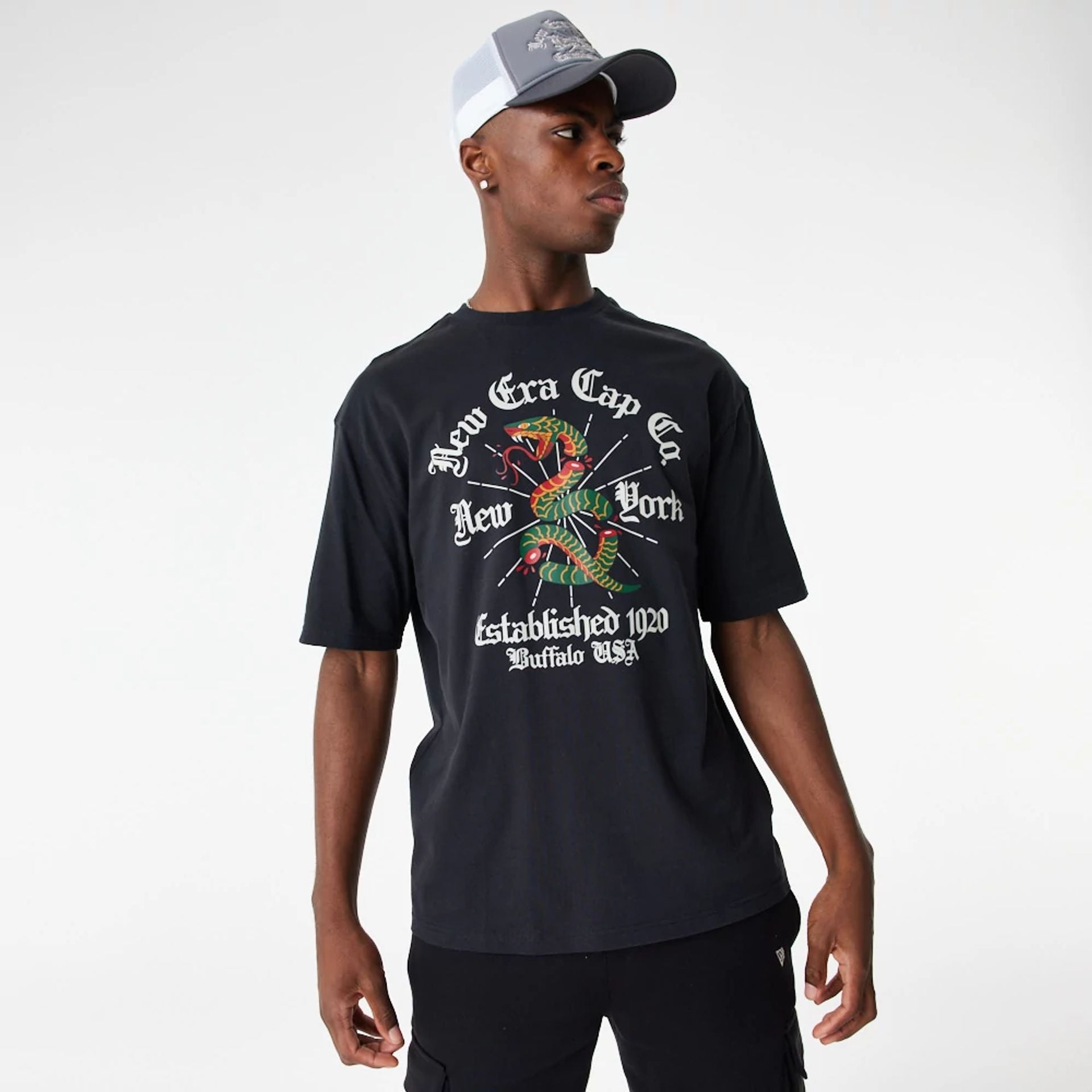 The Male model is wearing New Era Graphic Severed Snake Black Oversized T-Shirt 2