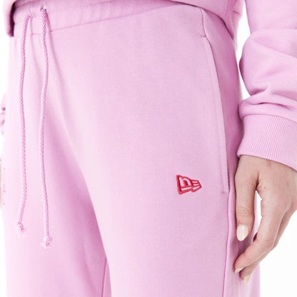 The Female model is wearing New Era Womens Arch Wordmark Pink Joggers 7