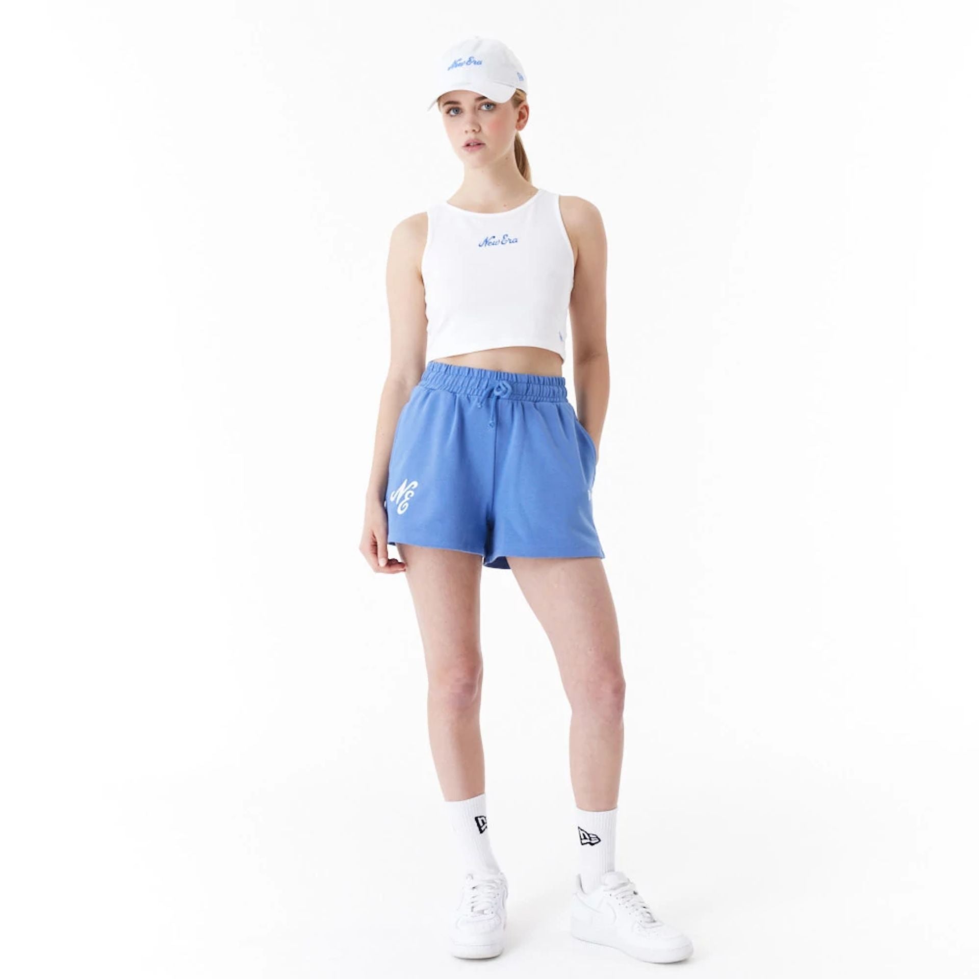 The Female model is wearing New Era Womens White Crop Tank Top 2