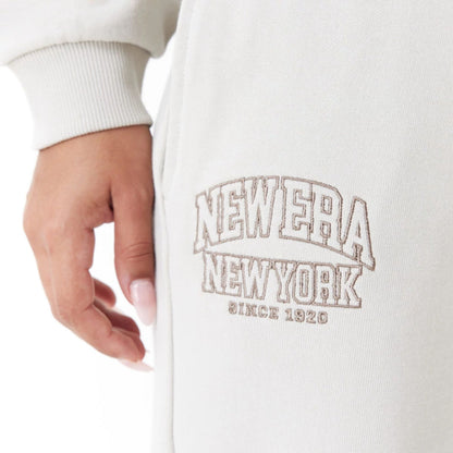 The Female model is wearing New Era Arch Wordmark Stone Womens Joggers 8