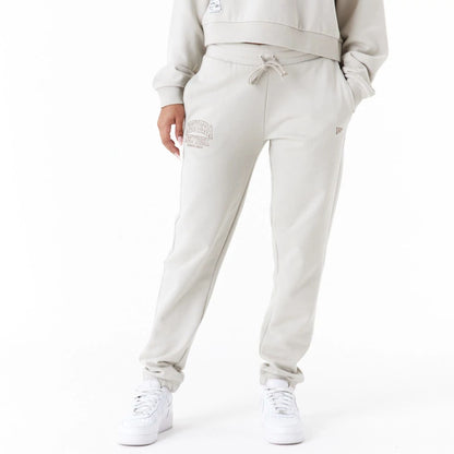 The Female model is wearing New Era Arch Wordmark Stone Womens Joggers 1