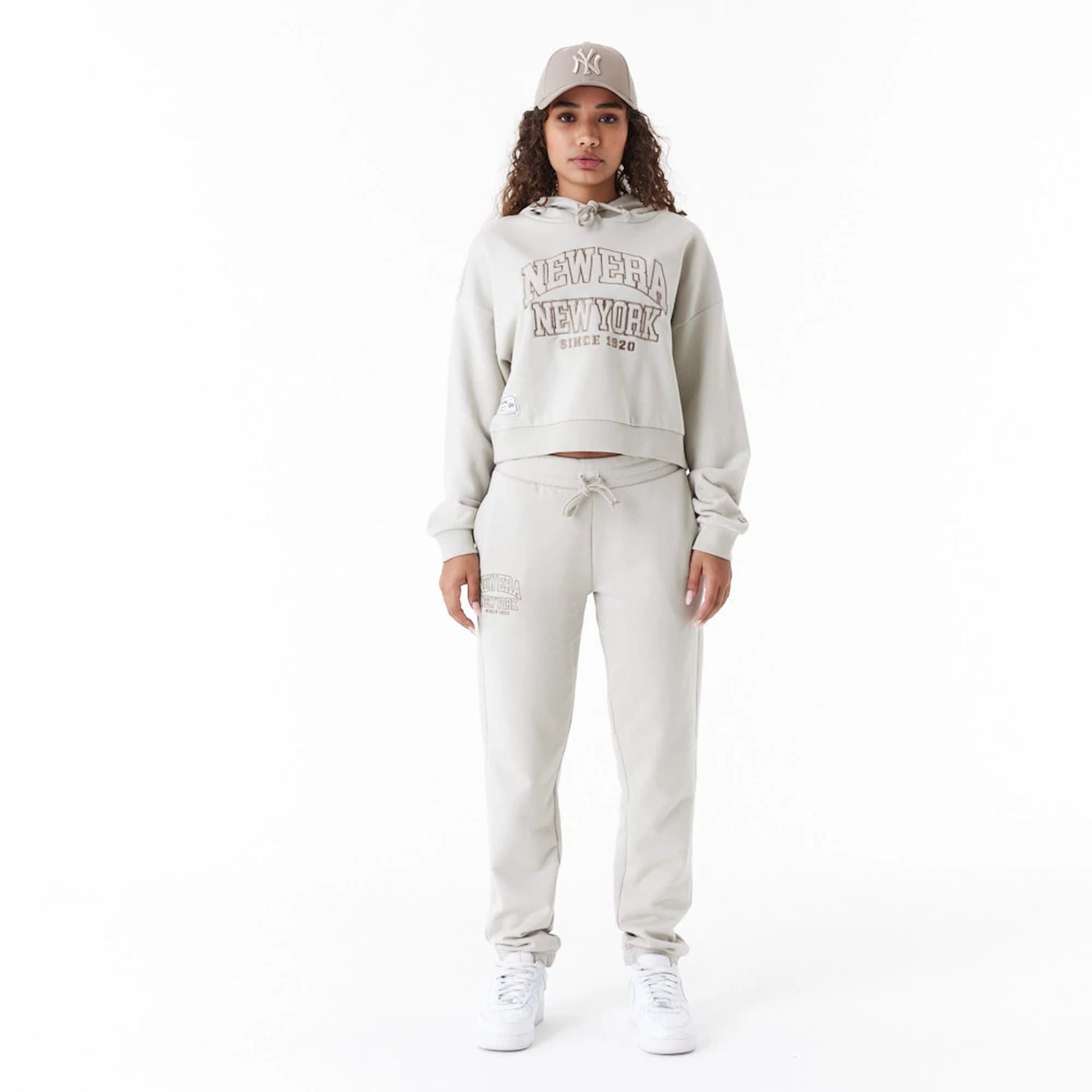 The Female model is wearing New Era Arch Wordmark Stone Womens Joggers 5