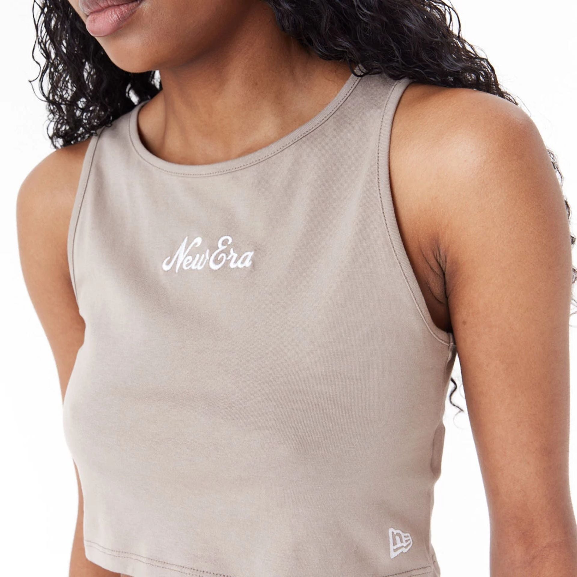 The Female model is wearing New Era Womens Brown Crop Tank Top 8