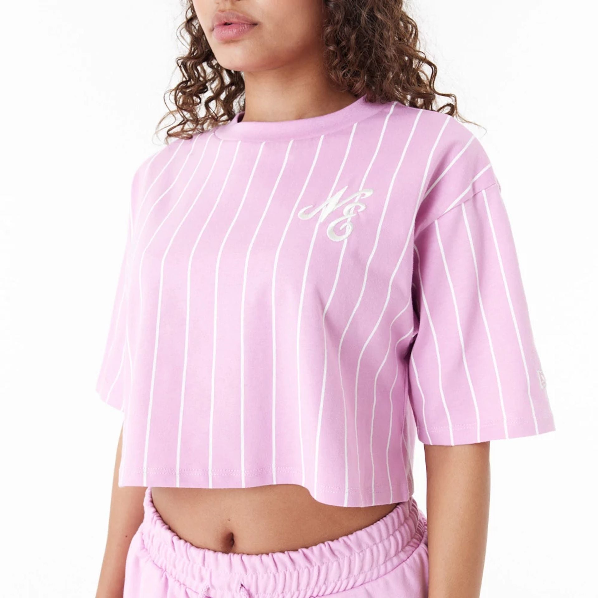 The Female model is wearing New Era Pinstripe Pink Womens Crop T-Shirt 7