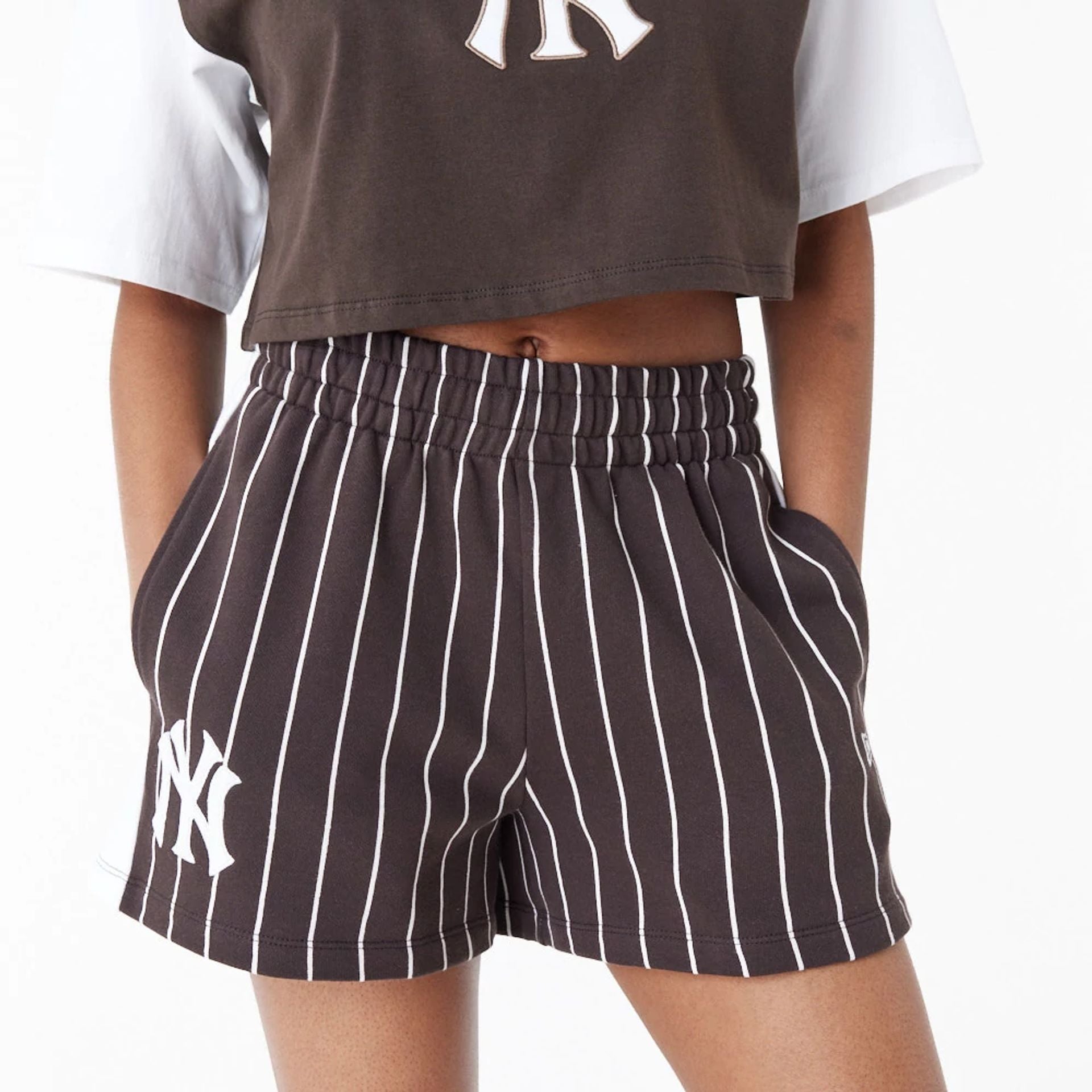 The Female model is wearing New York Yankees MLB Lifestyle Brown Shorts 7