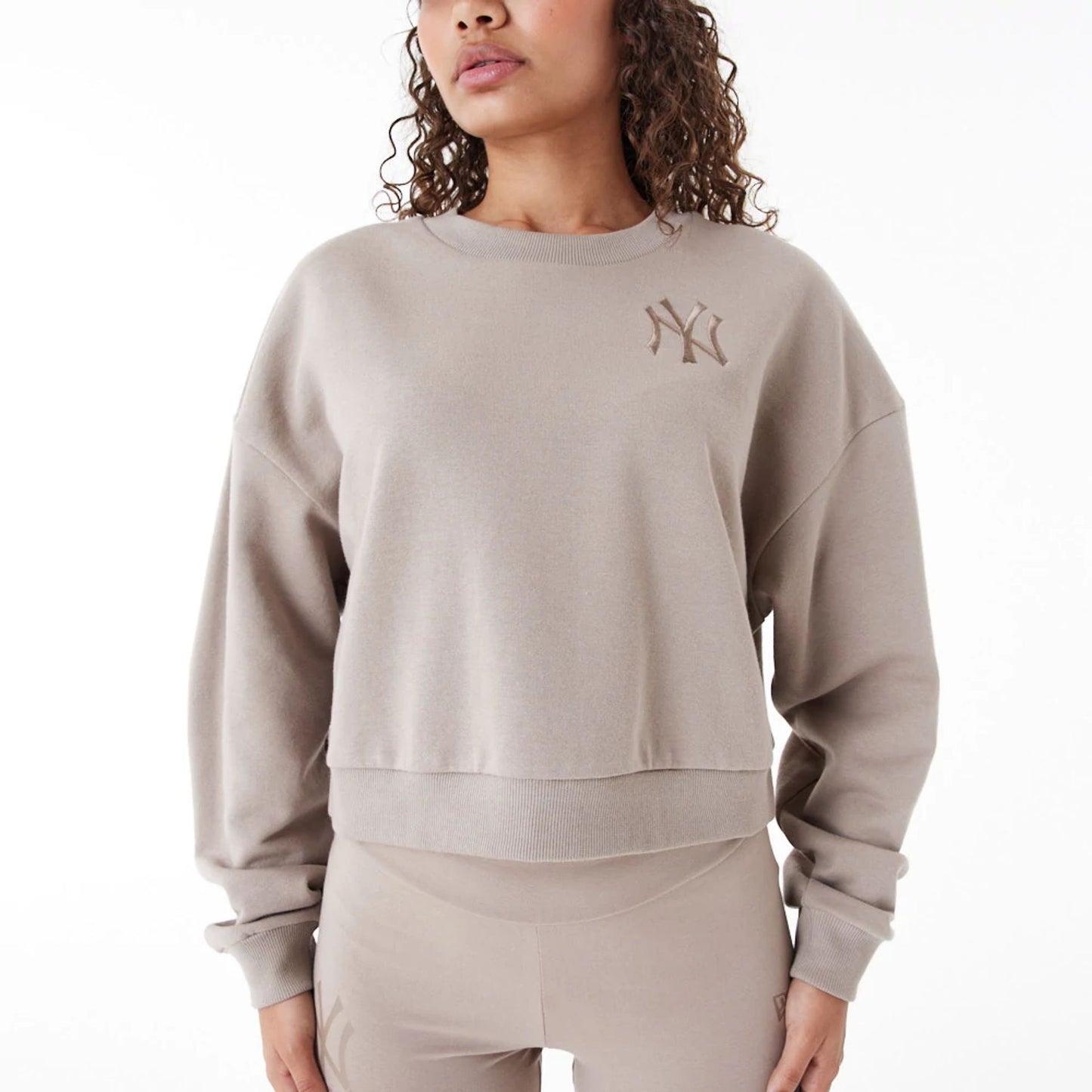 The Female model is wearing New York Yankees Womens MLB Lifestyle Brown Crop Crew Neck Sweatshirt 6