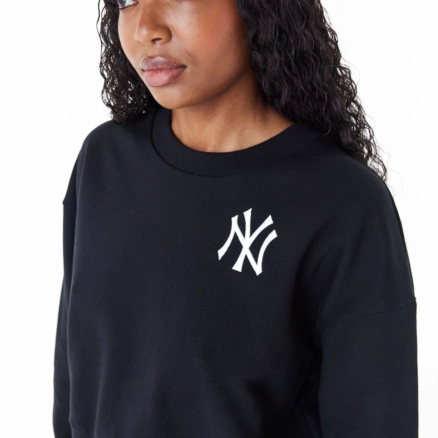 The Female model is wearing New York Yankees Womens MLB Lifestyle Black Crop Crew Neck Sweatshirt 7