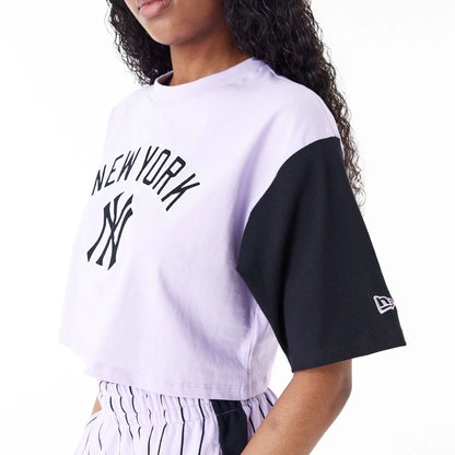 The Female model is wearing New York Yankees MLB Lifestyle Purple Womens Crop T-Shirt 3