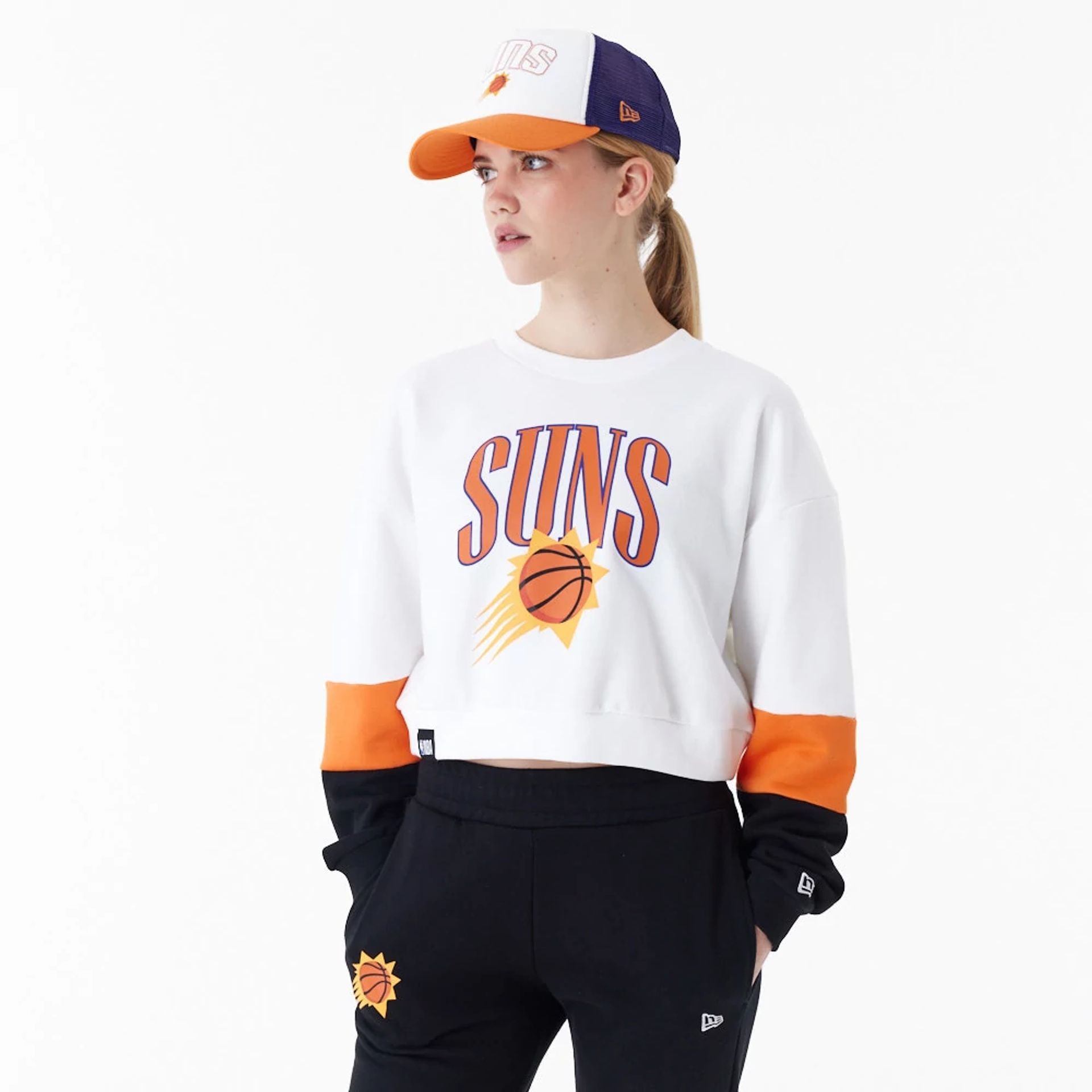 The Female model is wearing Phoenix Suns Womens NBA Colour Block White Crop Crew Neck Sweatshirt 1