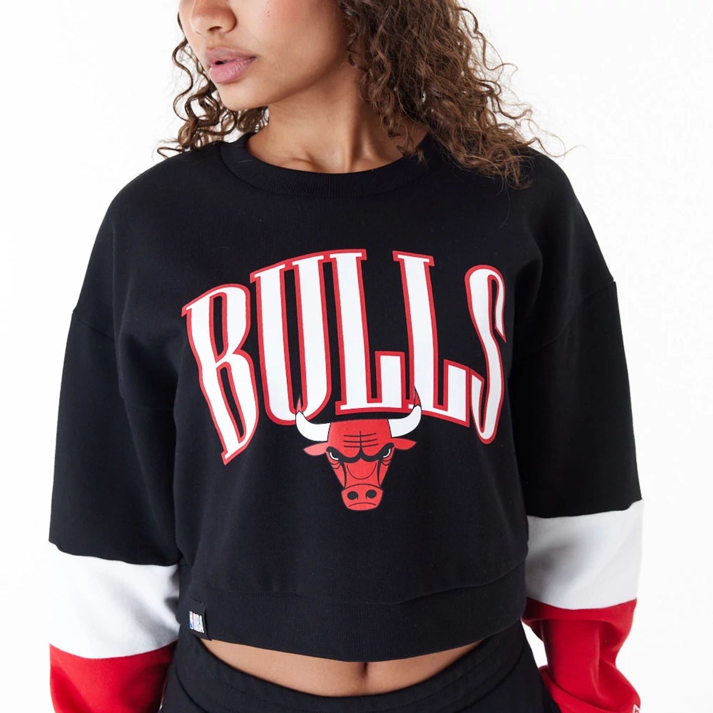 The Female model is wearing Chicago Bulls Womens NBA Colour Block Black Crop Crew Neck Sweatshirt 2