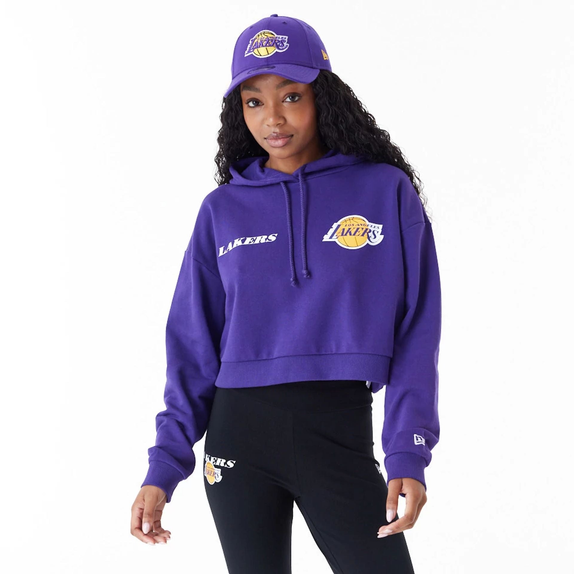 The Female model is wearing LA Lakers Womens NBA Team Logo Purple Crop Pullover Hoodie 1