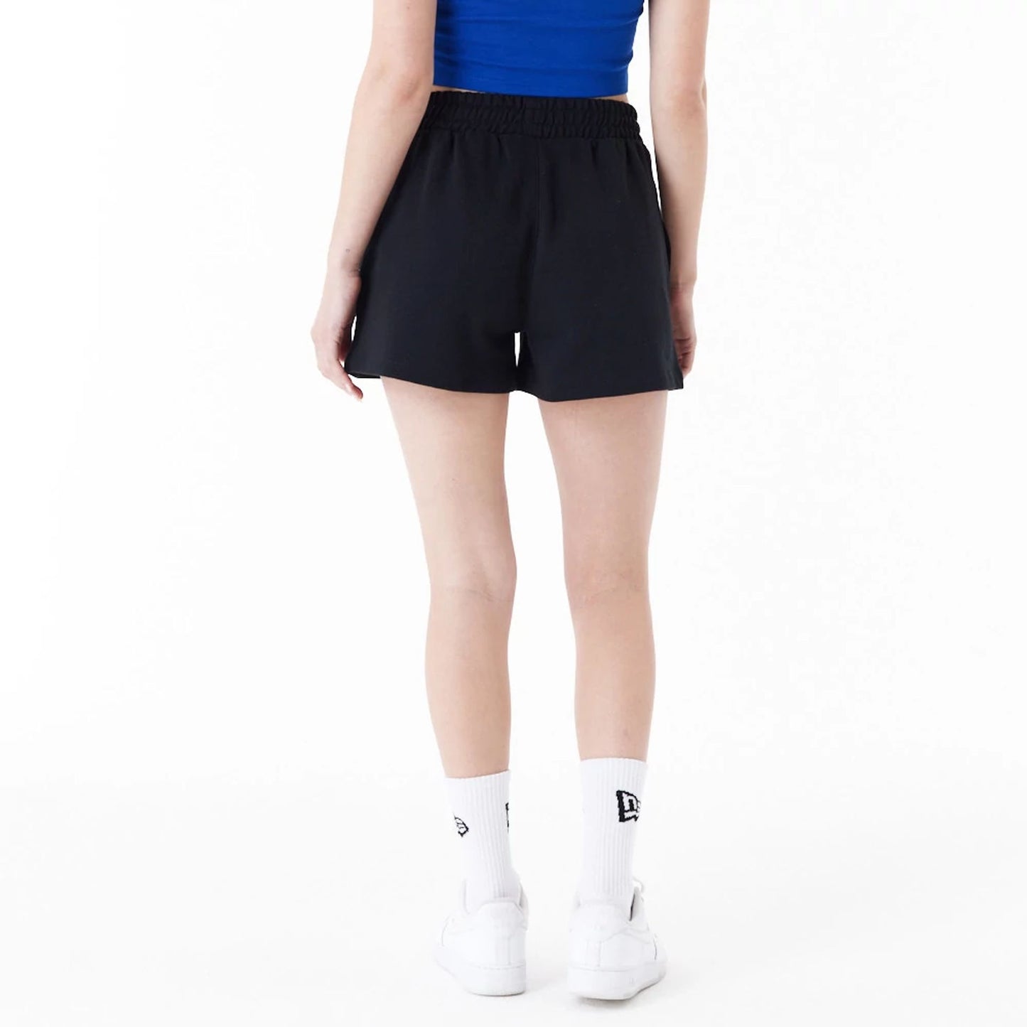 The Female model is wearing New York Knicks Womens NBA Team Logo Black Shorts 2