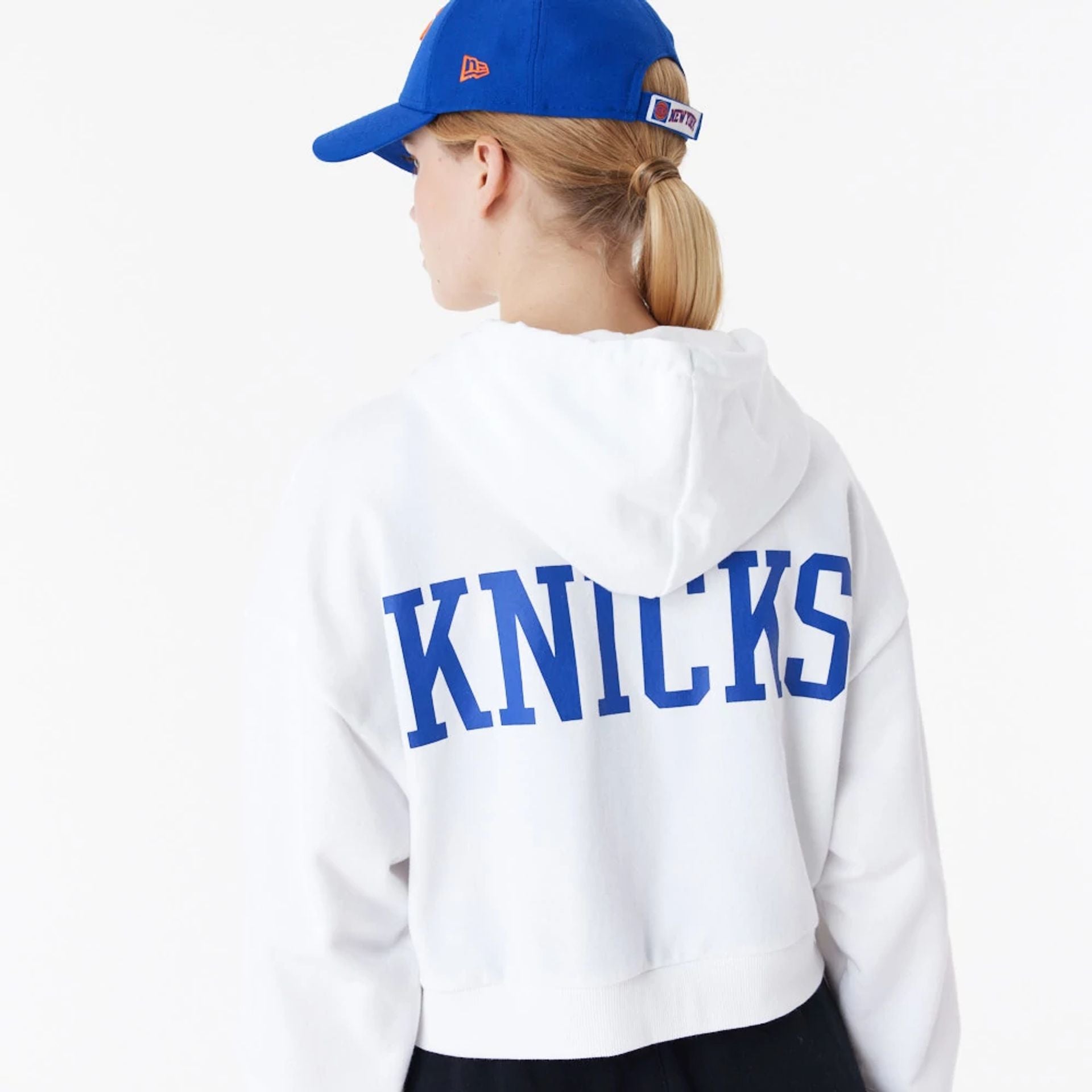 The Female model is wearing New York Knicks Womens NBA Team Logo White Crop Pullover Hoodie 6