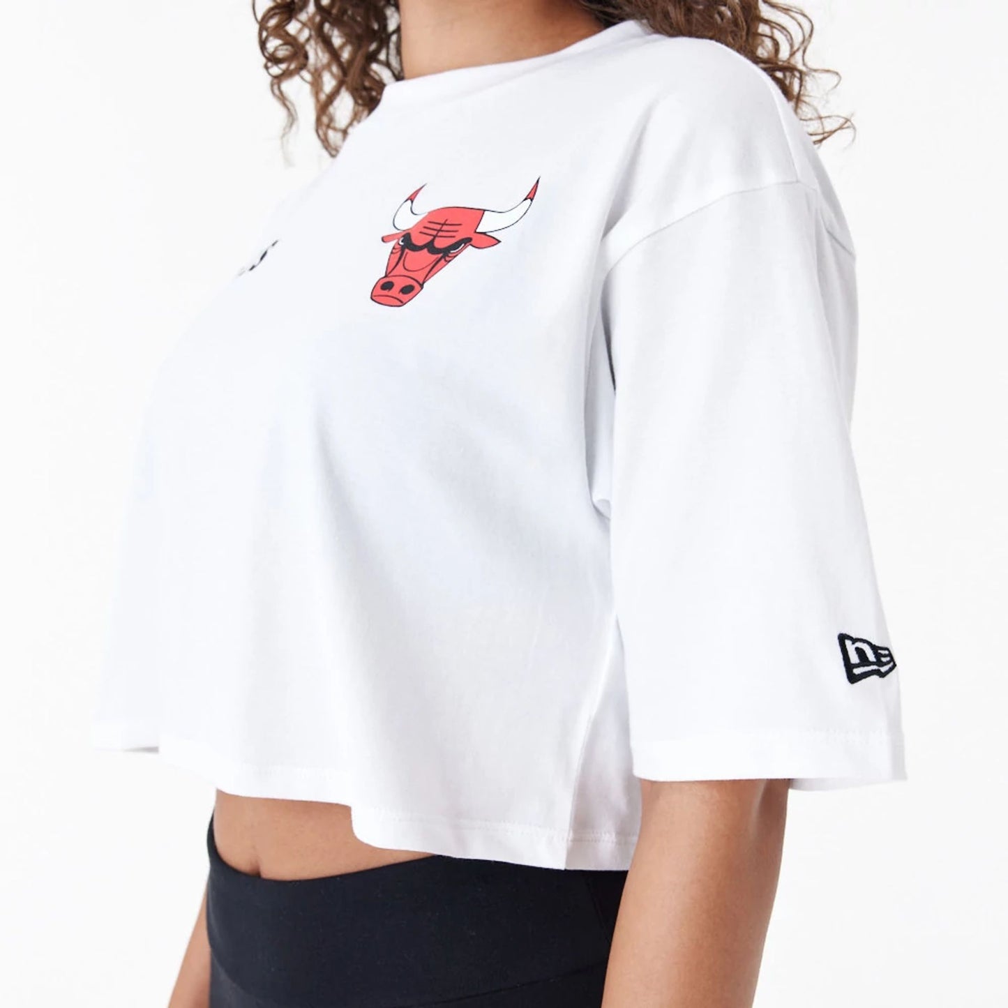 The Female model is wearing Chicago Bulls Womens NBA Team Logo White Crop T-Shirt 6