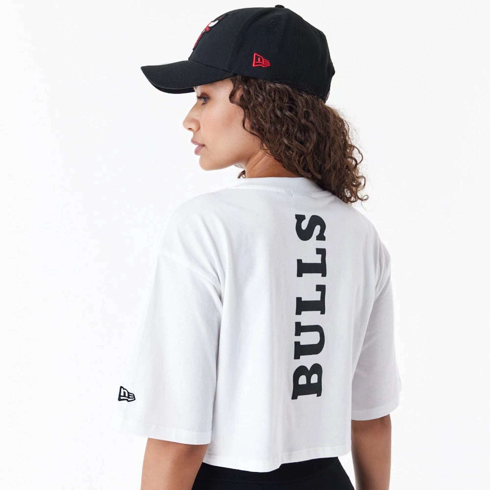 The Female model is wearing Chicago Bulls Womens NBA Team Logo White Crop T-Shirt 3