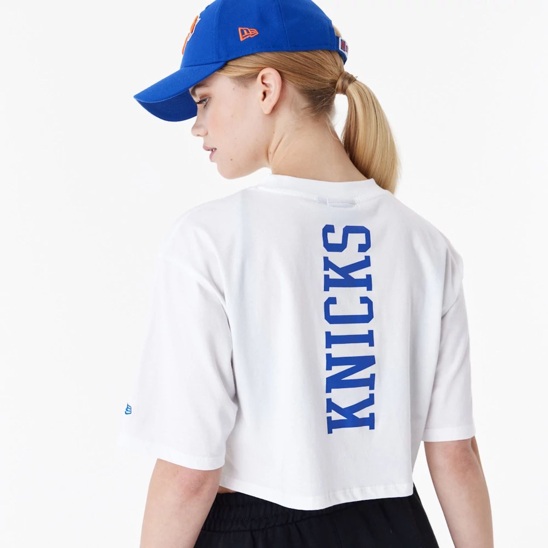 The Female model is wearing New York Knicks Womens NBA Team Logo White Crop T-Shirt 5