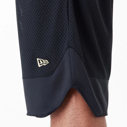 The Male model is wearing New Era Black Oversized Mesh Shorts 3