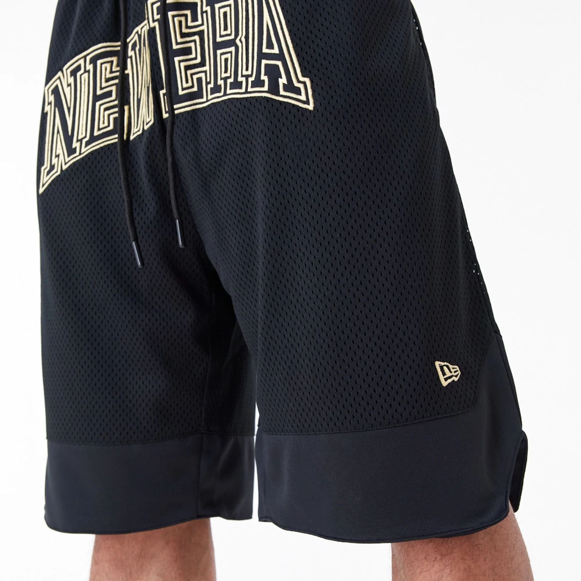 The Male model is wearing New Era Black Oversized Mesh Shorts 4