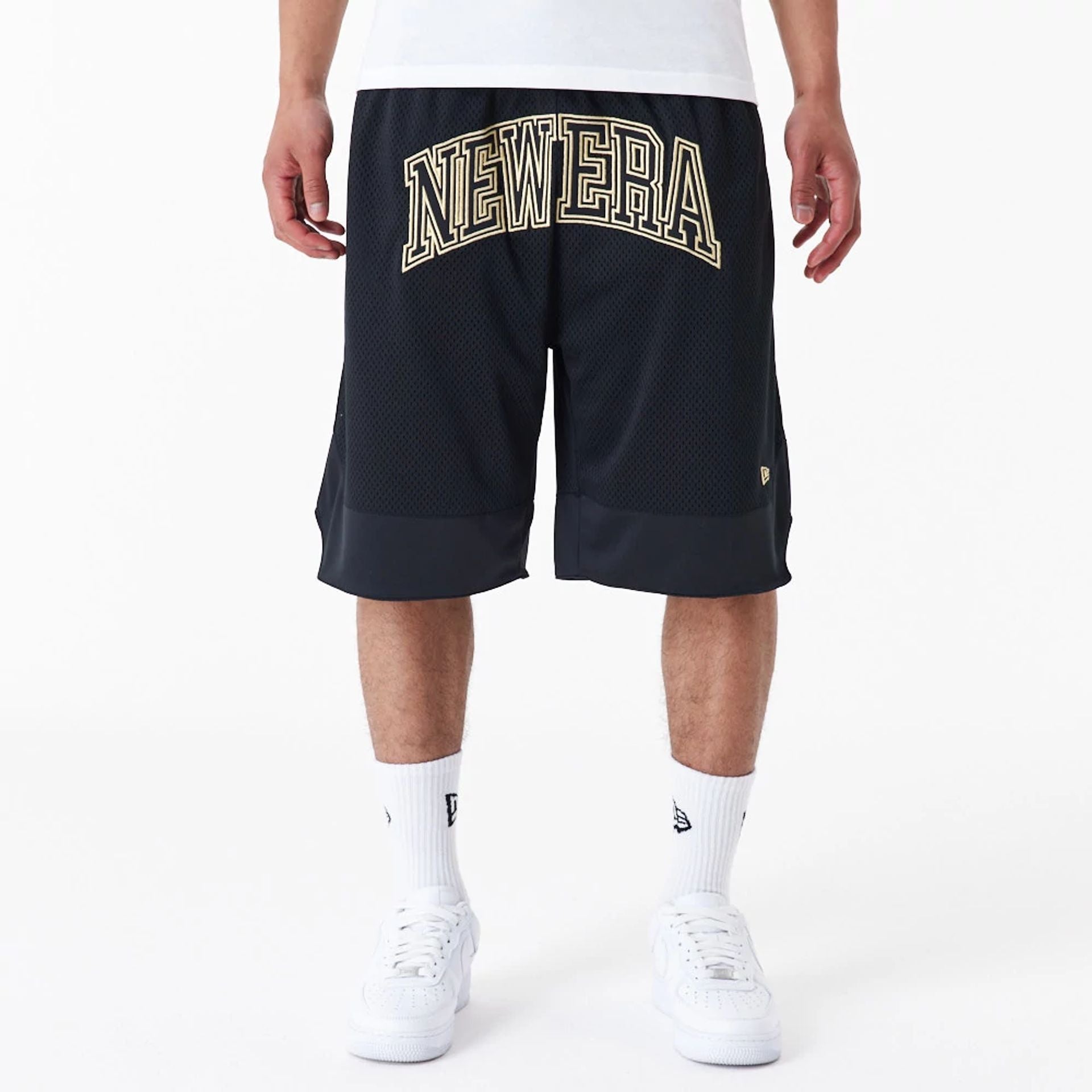 The Male model is wearing New Era Black Oversized Mesh Shorts 1