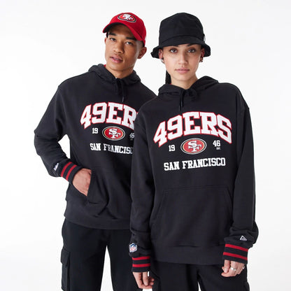 The Male model is wearing San Francisco 49Ers NFL Black Oversized Pullover Hoodie 1