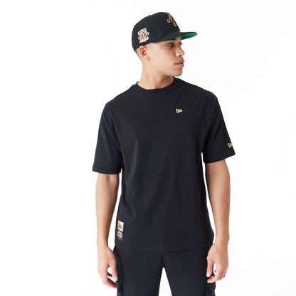 The Male model is wearing New Era Graphic Black Oversized T-Shirt 1