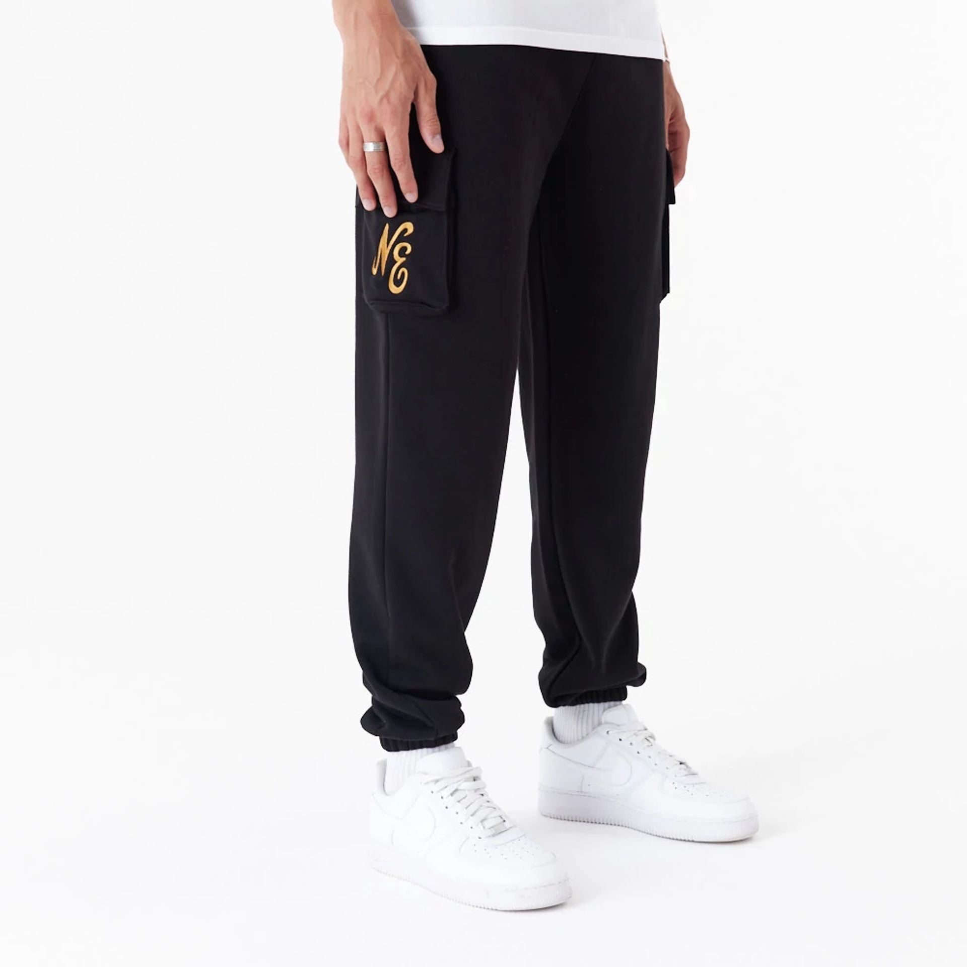 The Male model is wearing New Era Script Black Cargo Joggers 11