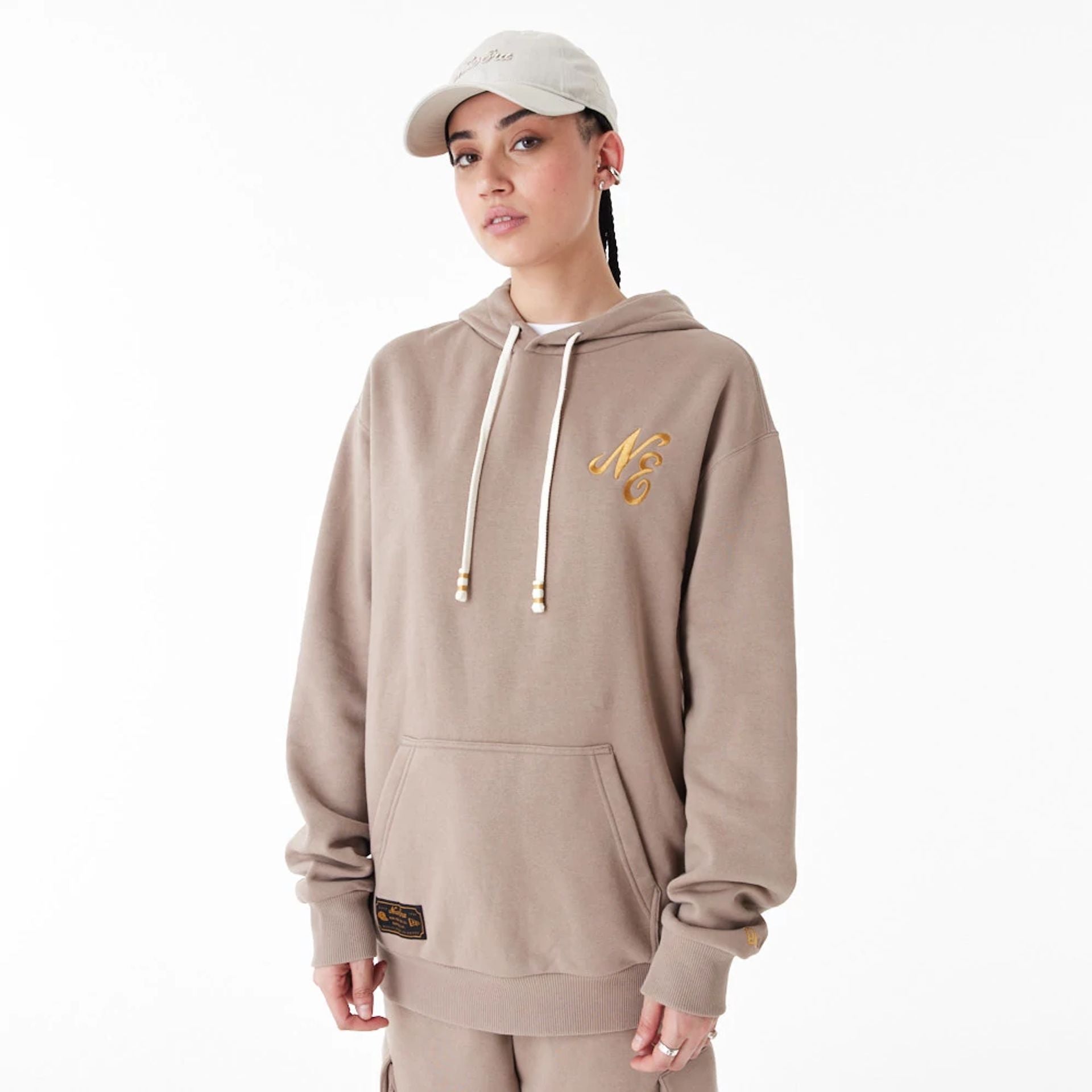 The Male model is wearing New Era Script Logo Brown Oversized Pullover Hoodie 9