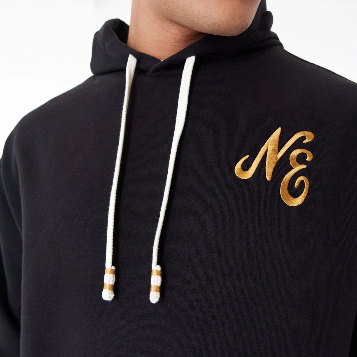 The Male model is wearing New Era Script Logo Black Oversized Pullover Hoodie 8