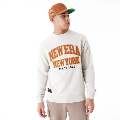 The Male model is wearing New Era Arch Graphic Stone Crew Neck Sweatshirt 7