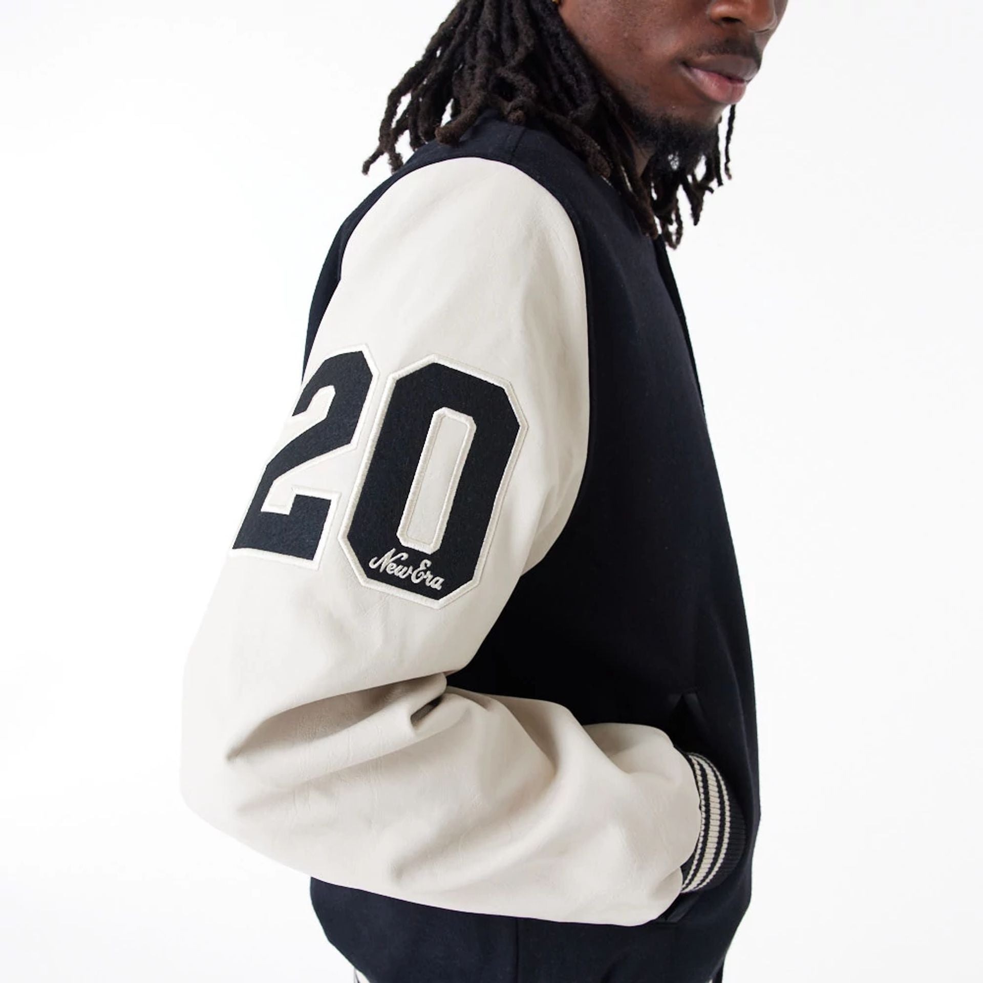 The Male model is wearing New Era Script Logo Black Varsity Jacket 5