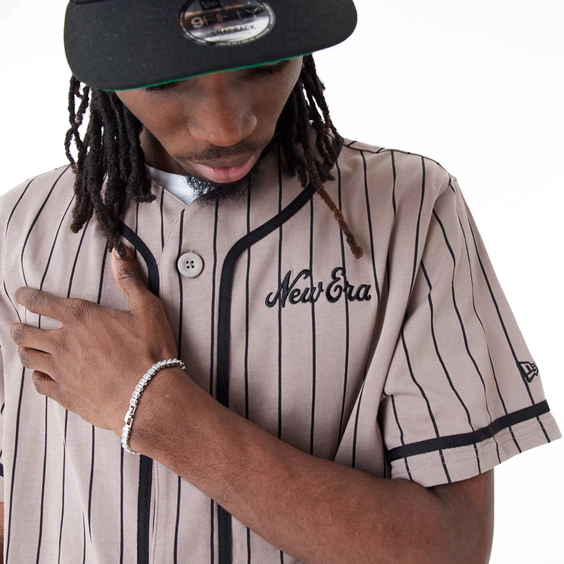 The Male model is wearing New Era Pinstripe Brown Jersey 5