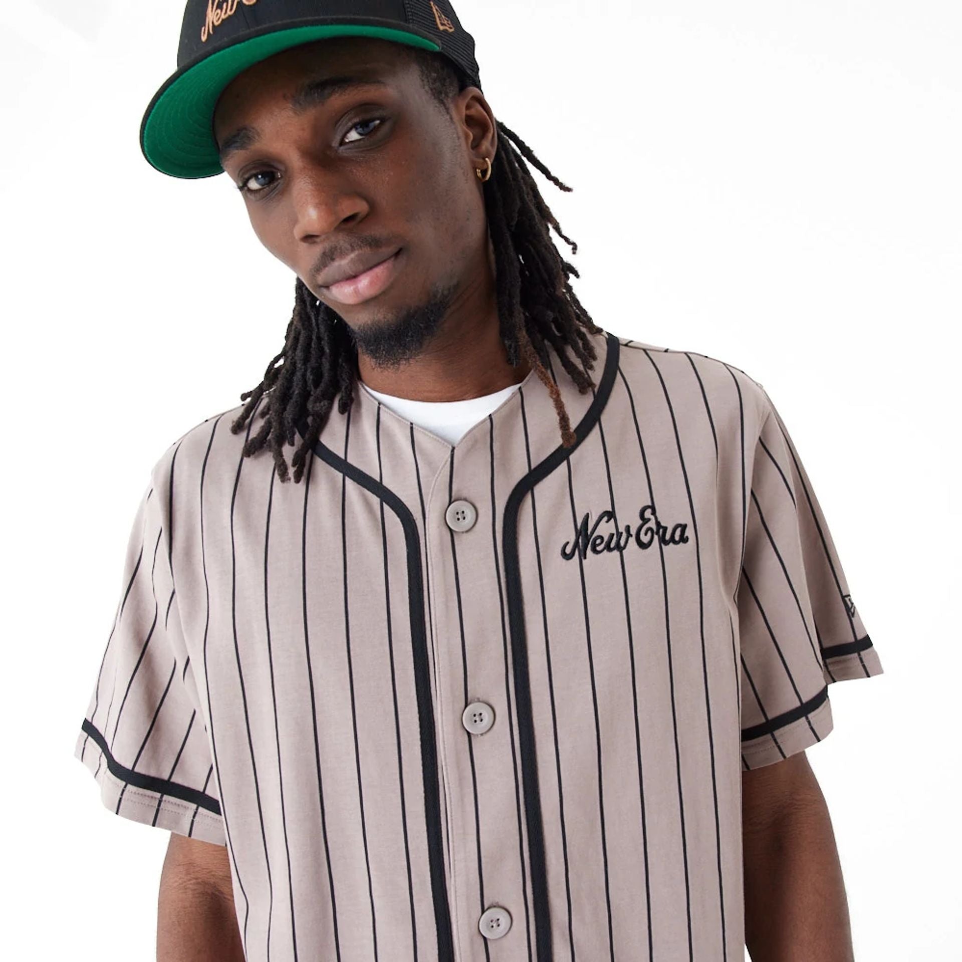 The Male model is wearing New Era Pinstripe Brown Jersey 2