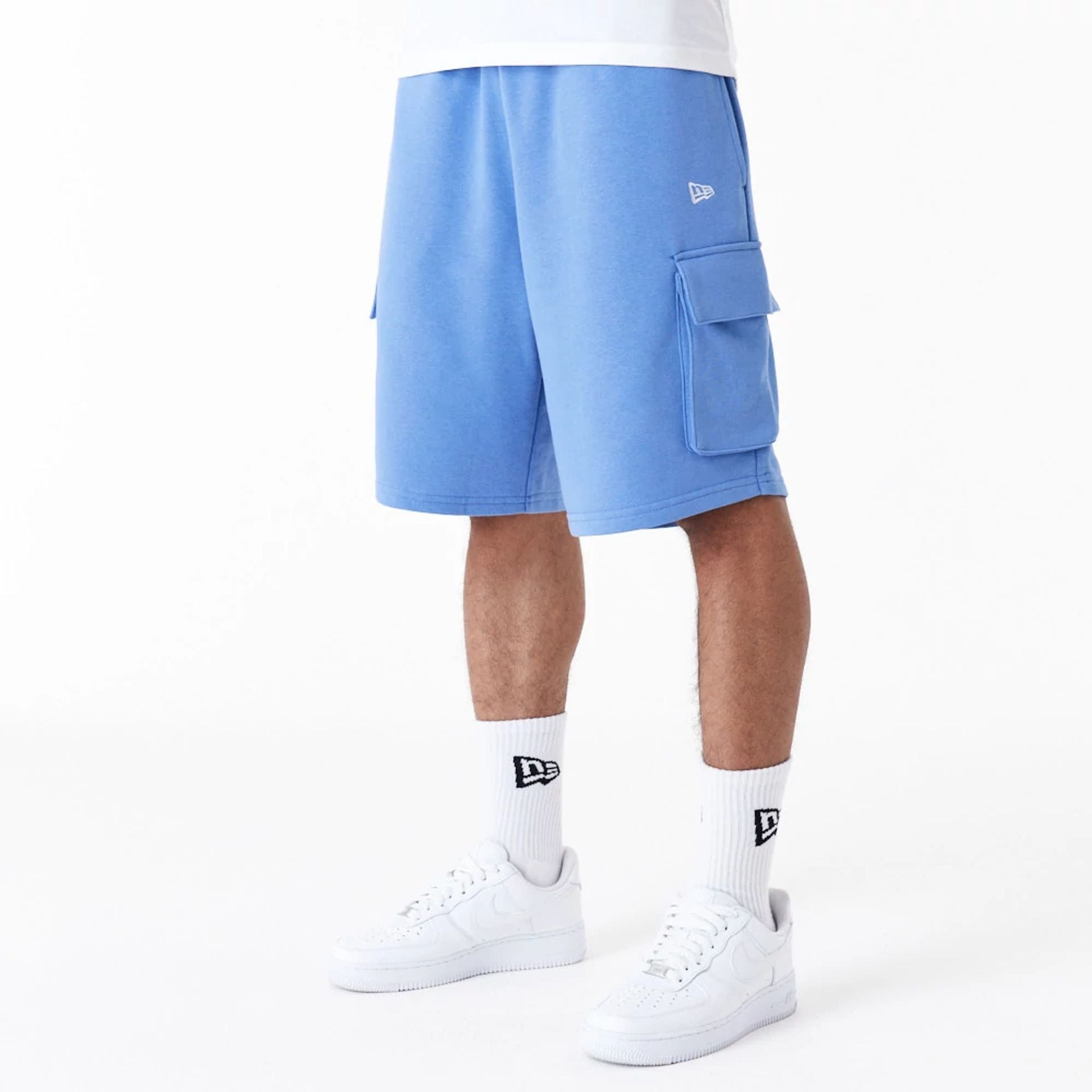 The Male model is wearing New Era Essential Blue Cargo Shorts 2