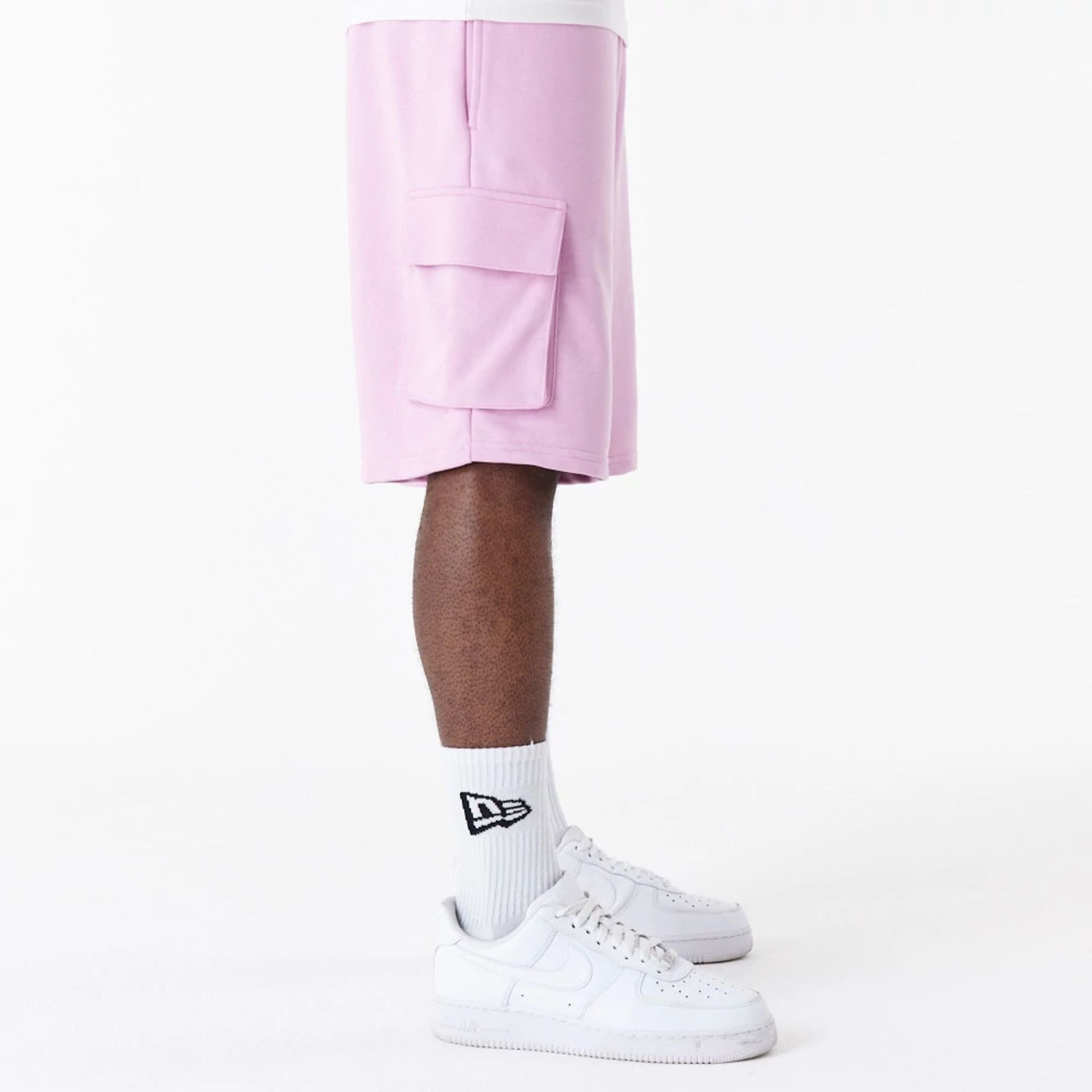 The Male model is wearing New Era Essential Pink Cargo Shorts 5