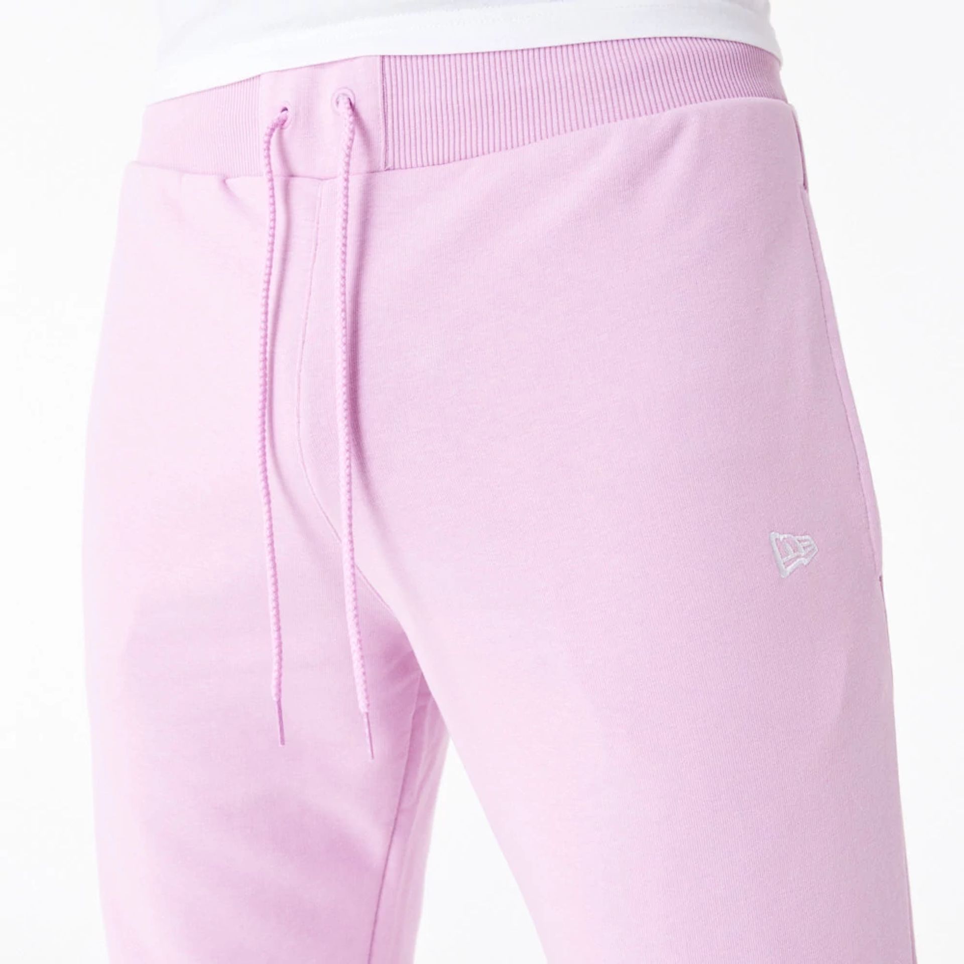 The Male model is wearing New Era Essential Pink Slim Joggers 3