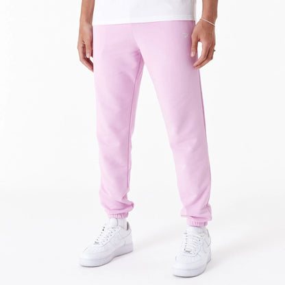 The Male model is wearing New Era Essential Pink Slim Joggers 1