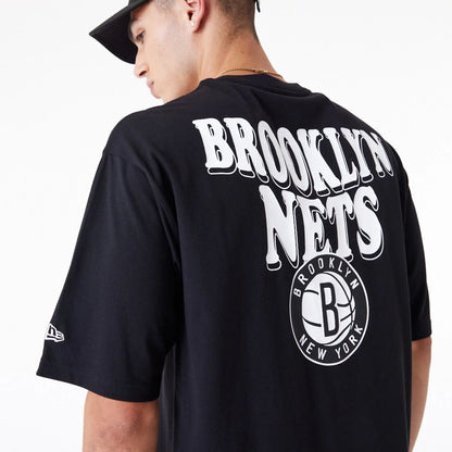 The Male model is wearing Brooklyn Nets NBA Script Black Oversized T-Shirt 2