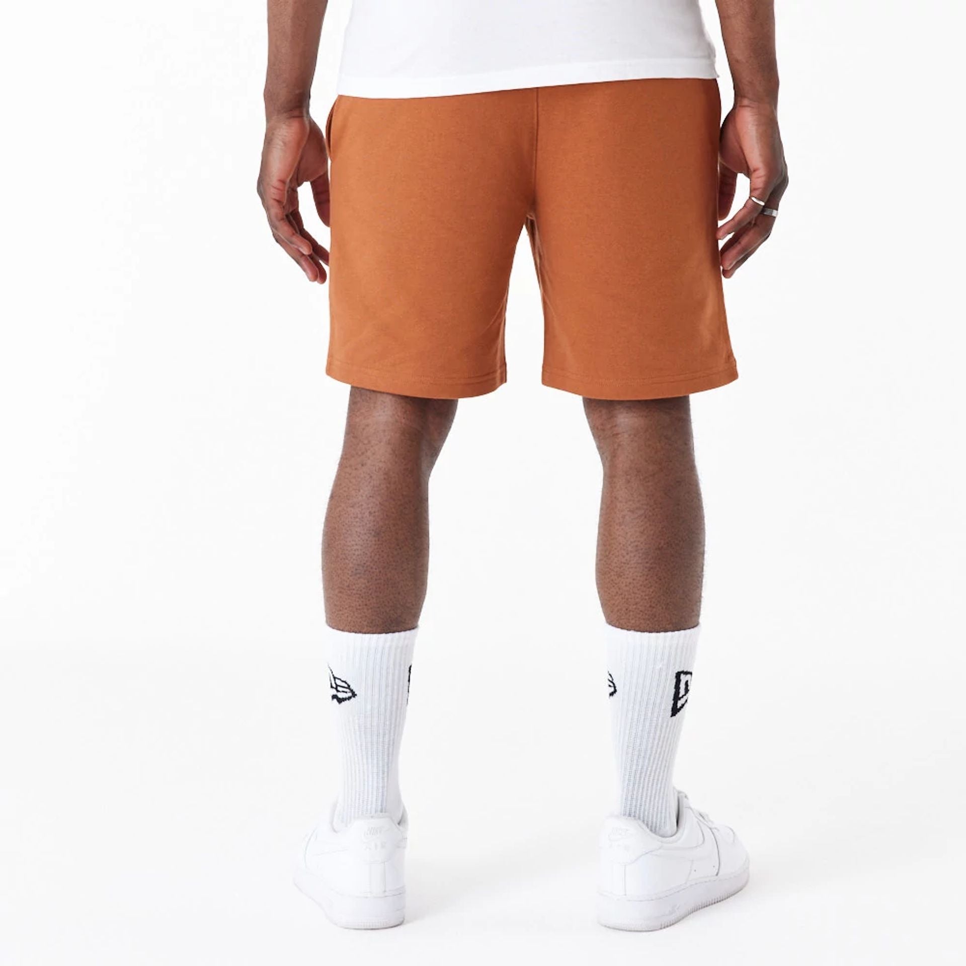 The Male model is wearing New York Yankees League Essential Brown Shorts 7